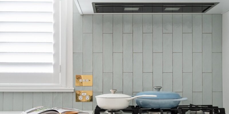 a grey kitchen with splashback